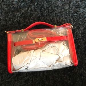 clear purse, with red outside lining
